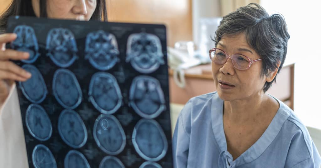 Elderly woman being diagnosed with Alzheimer's disease by doctor